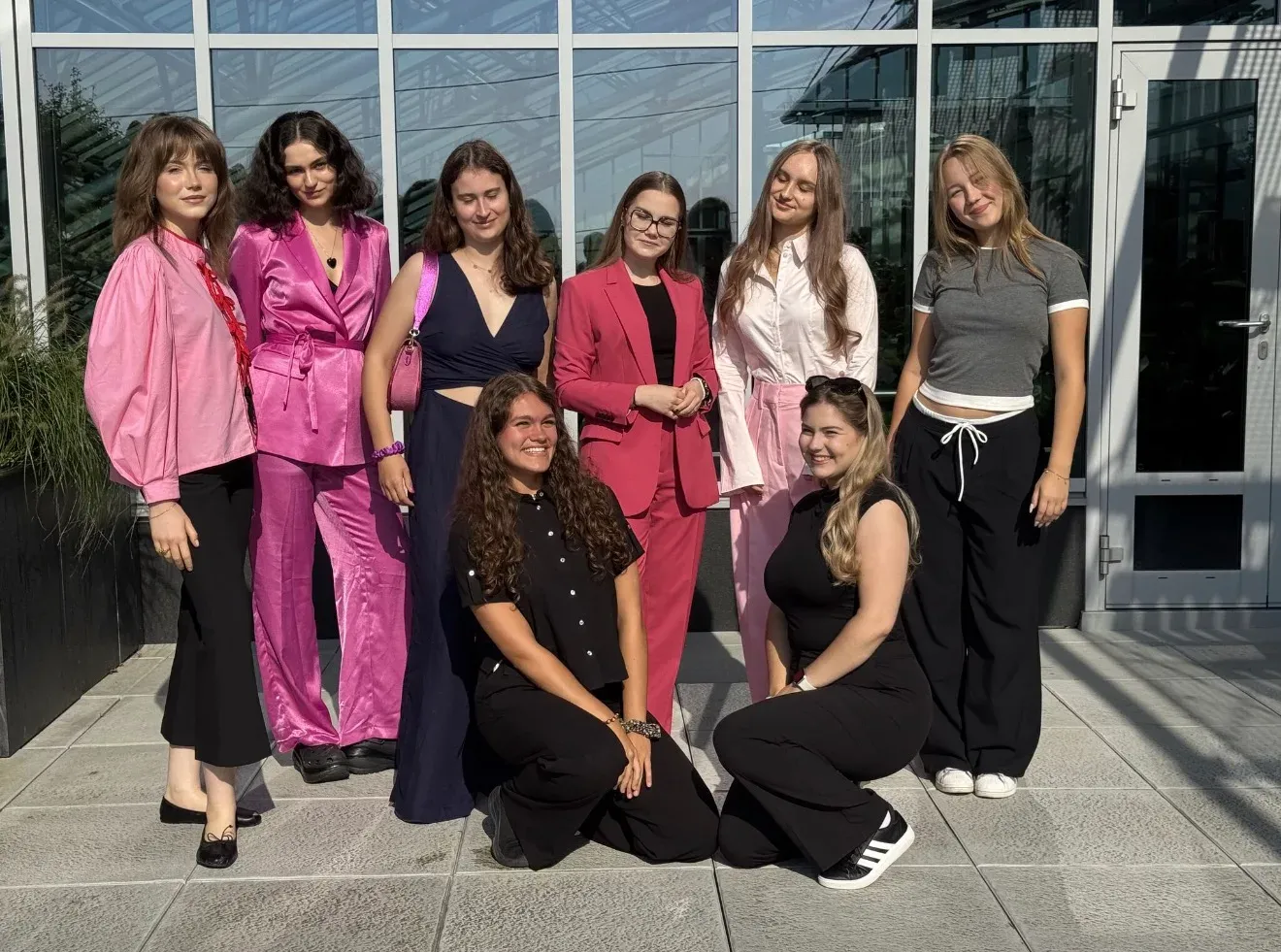 Eight young women of the Girls Future Ready community standing together outside