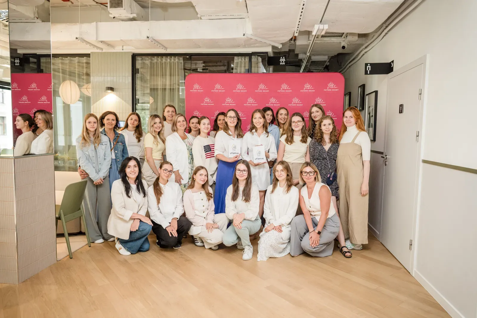 The Girls Future Ready team and programme participants together in front of the foundation's backdrop