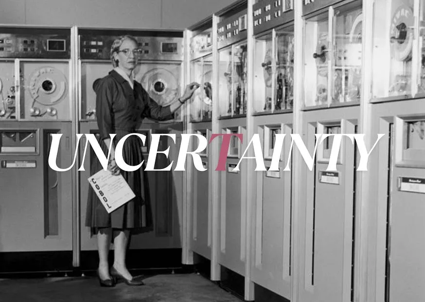 The word UNCERTAINTY set across a photograph of a woman in glasses at a wall of mid-century computing equipment, holding a printout