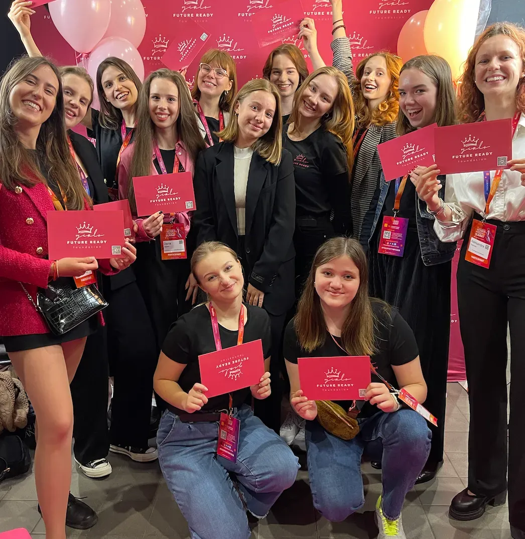 Participants at a Girls Future Ready event holding the foundation’s cards