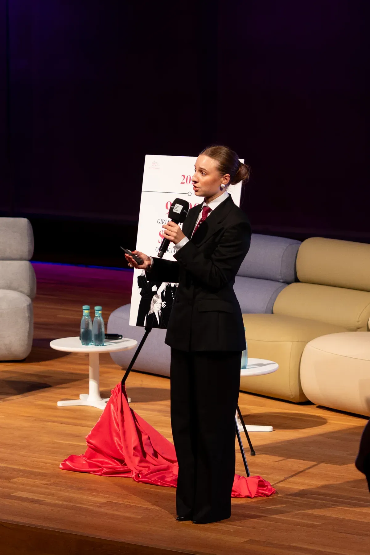 Zofia Kierner speaking on stage beside an unveiled Girls Future Ready board